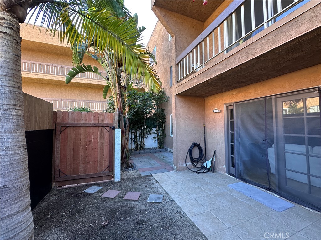 6600 Warner Avenue, Unit 210 Huntington Beach, CA 92647 - Photo 35 of 47 a view of a house with a patio and wooden fence