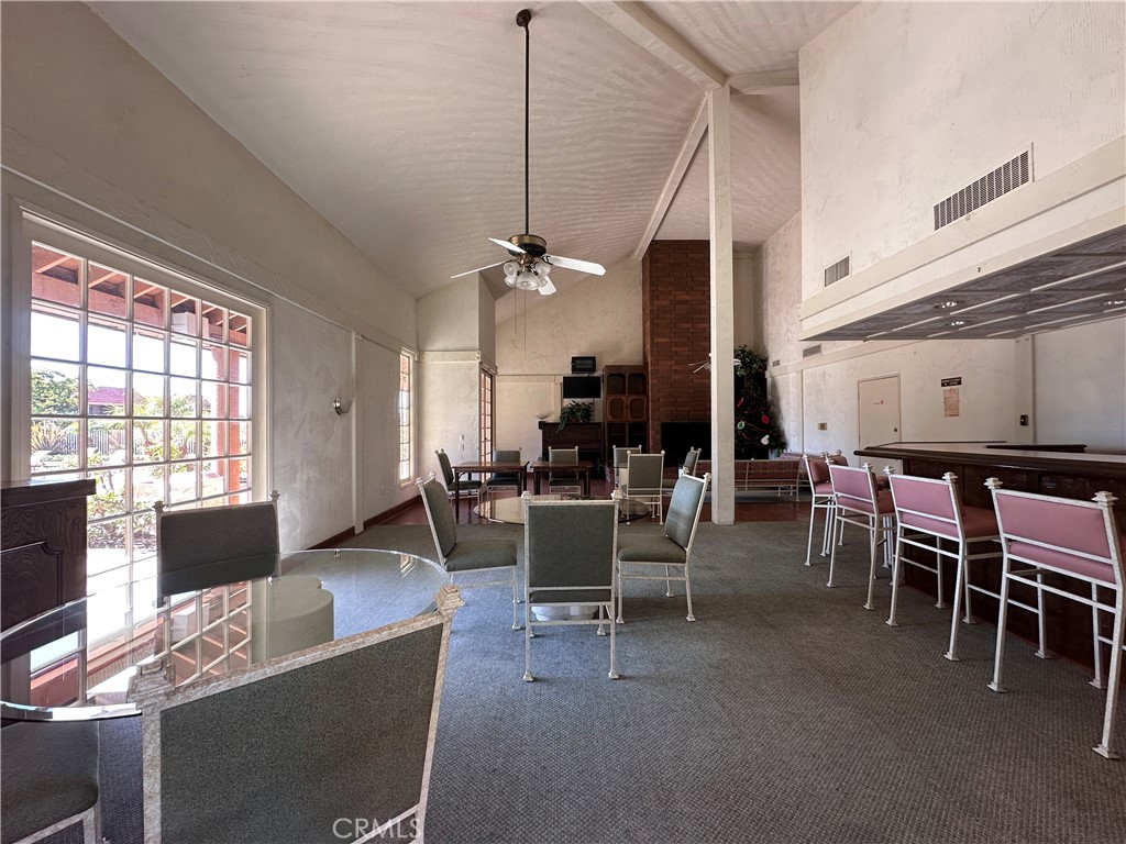 6600 Warner Avenue, Unit 210 Huntington Beach, CA 92647 - Photo 37 of 47 a living room with furniture a flat screen tv and a window