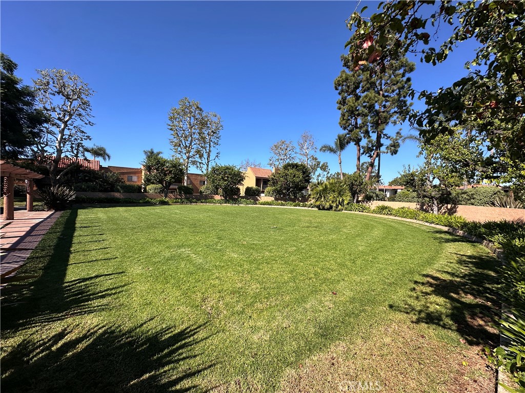 6600 Warner Avenue, Unit 210 Huntington Beach, CA 92647 - Photo 39 of 47 a view of a golf course with a garden