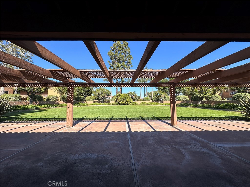 6600 Warner Avenue, Unit 210 Huntington Beach, CA 92647 - Photo 40 of 47 a view of yard with table and chairs under an umbrella