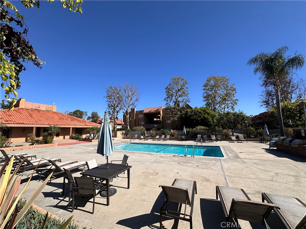 6600 Warner Avenue, Unit 210 Huntington Beach, CA 92647 - Photo 44 of 47 a view of a chairs and table on the terrace