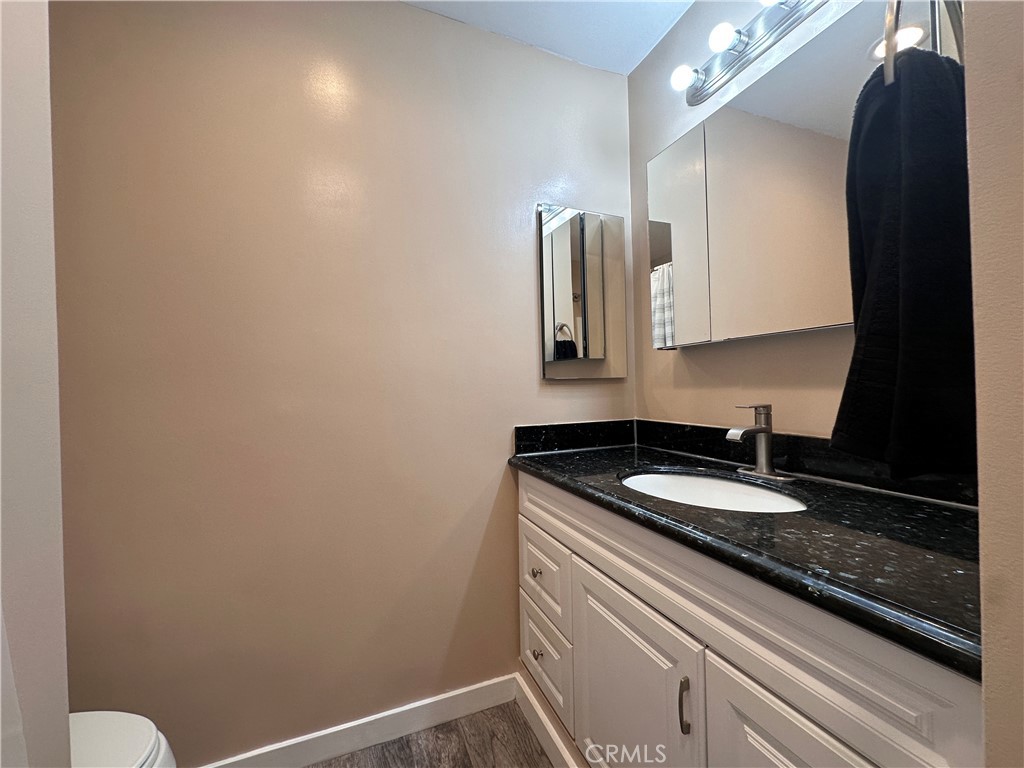 6600 Warner Avenue, Unit 210 Huntington Beach, CA 92647 - Photo 47 of 47 a bathroom with a sink and a mirror