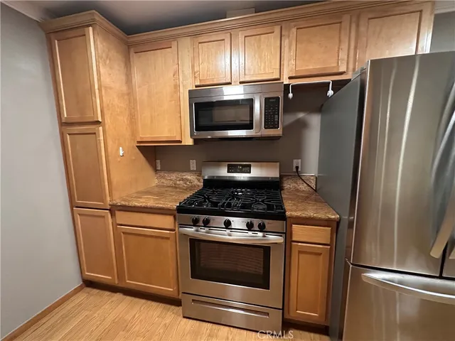 a kitchen with stainless steel appliances a refrigerator and a stove