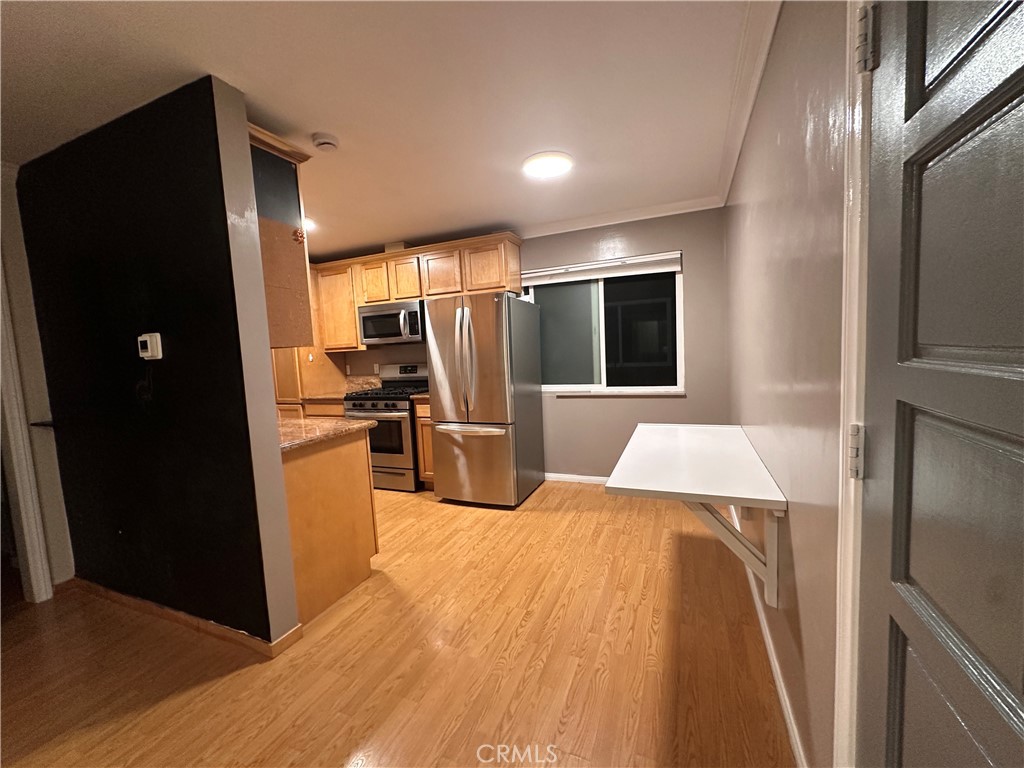 6600 Warner Avenue, Unit 210 Huntington Beach, CA 92647 - Photo 9 of 47 a kitchen with stainless steel appliances a refrigerator and a stove