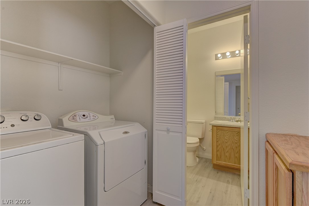 4613 Rising Cove Street Las Vegas, NV 89129 - Photo 15 of 20 This dedicated laundry space offers convenience with an adjacent well-appointed bathroom.