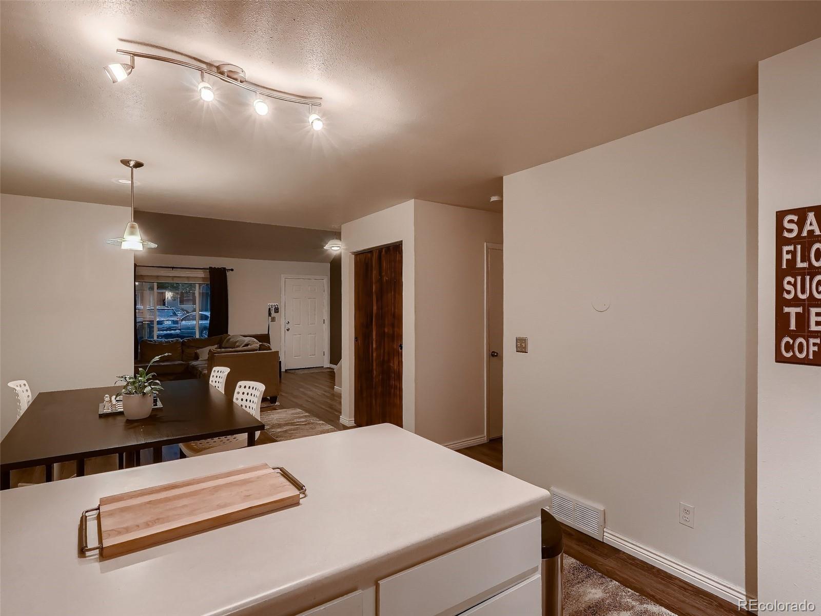 1230 South Reed Street, Unit 4 Lakewood, CO 80232 - Photo 11 of 28 a room with a table chairs and wooden floor