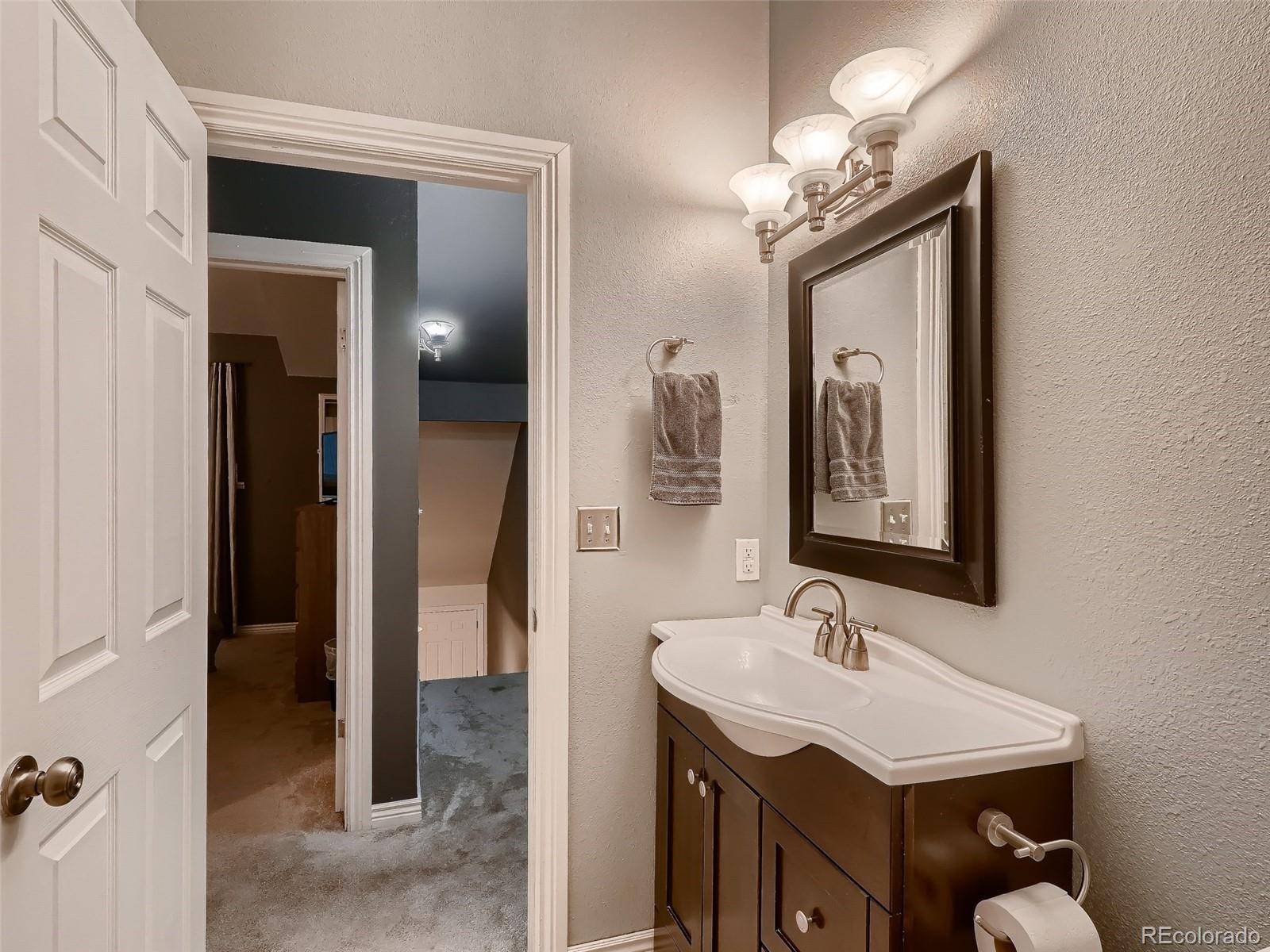 1230 South Reed Street, Unit 4 Lakewood, CO 80232 - Photo 16 of 28 a bathroom with a sink vanity and a mirror