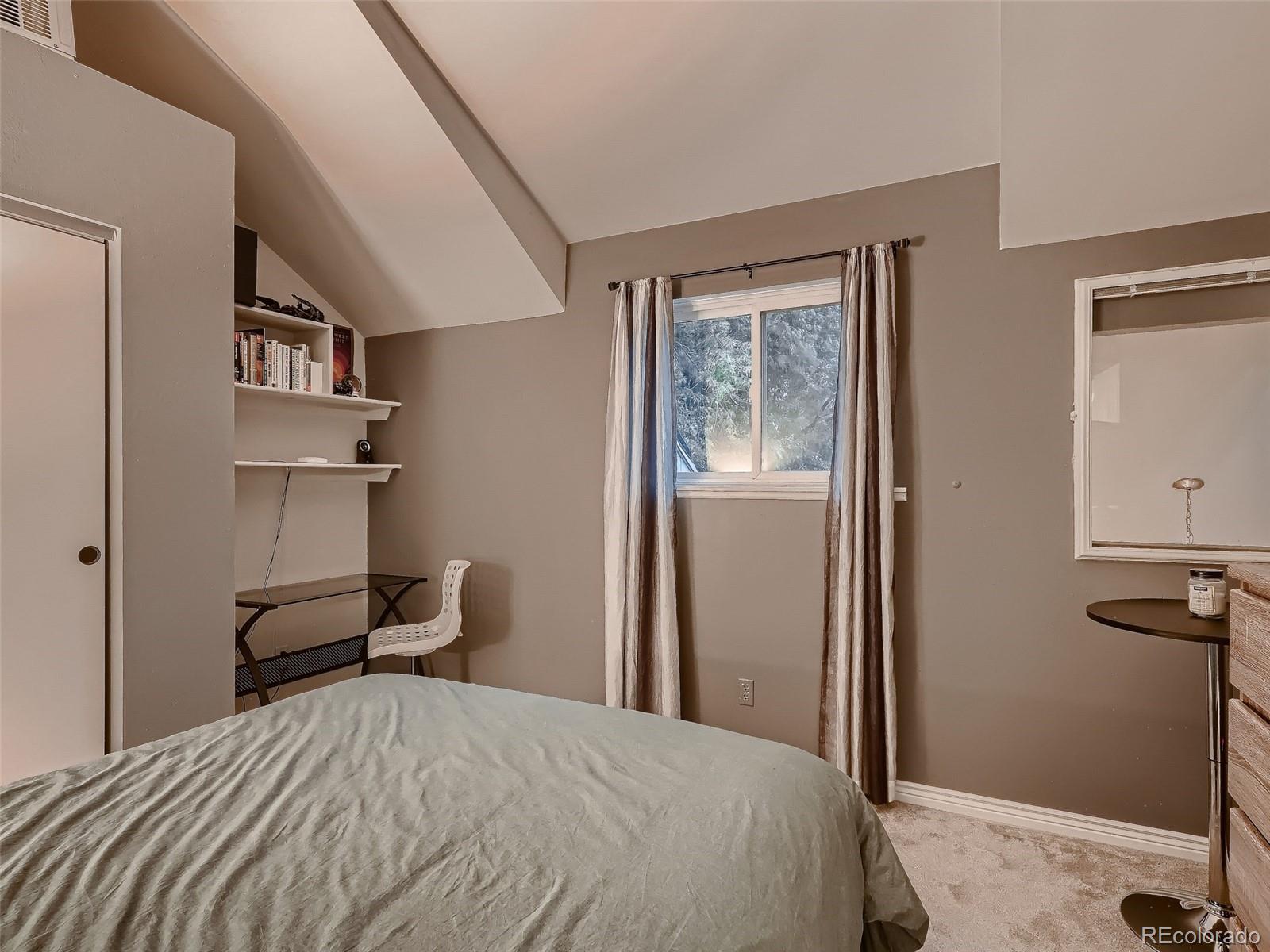 1230 South Reed Street, Unit 4 Lakewood, CO 80232 - Photo 17 of 28 a bedroom with a bed and a desk