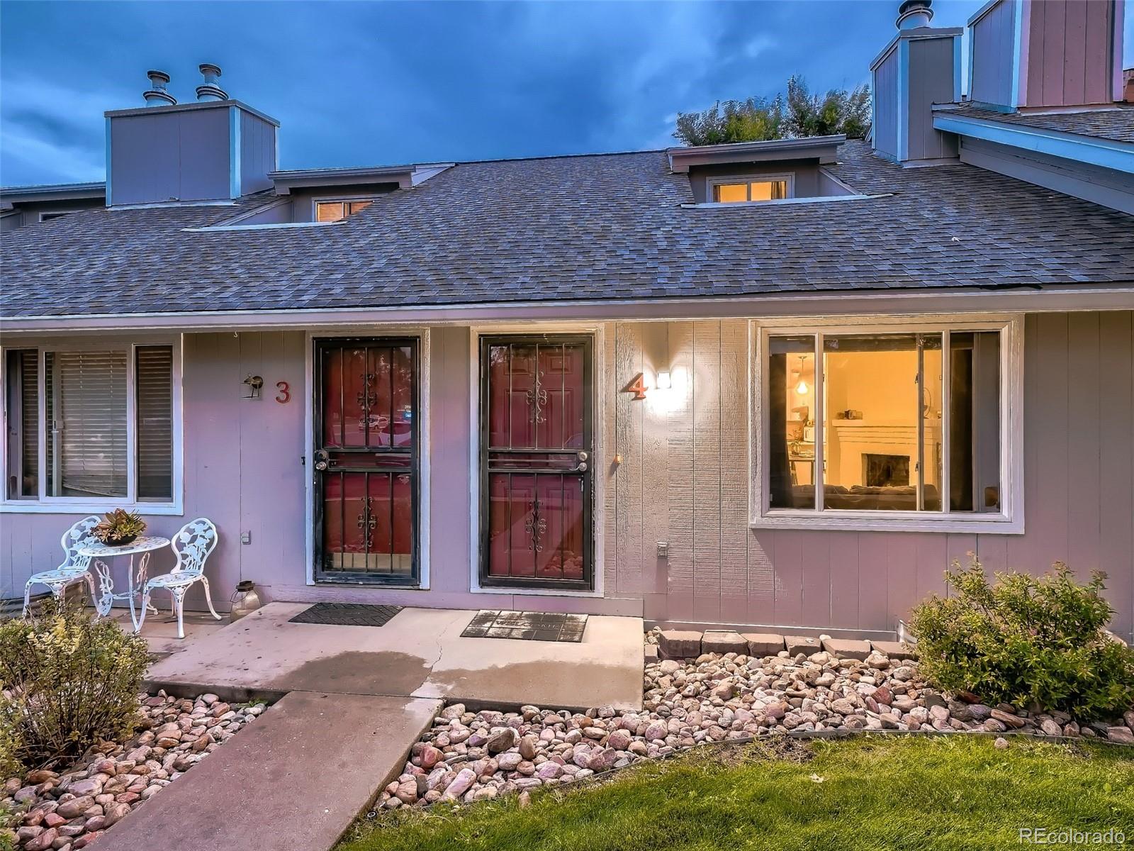 1230 South Reed Street, Unit 4 Lakewood, CO 80232 - Photo 2 of 28 a front view of a house with garden