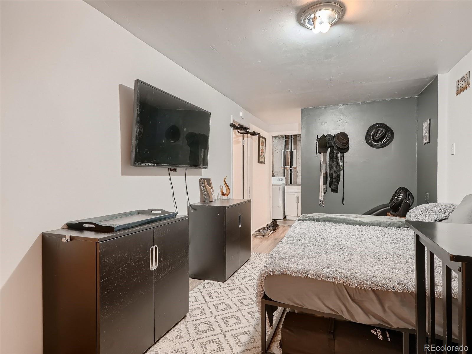 1230 South Reed Street, Unit 4 Lakewood, CO 80232 - Photo 22 of 28 a living room with furniture and a flat screen tv