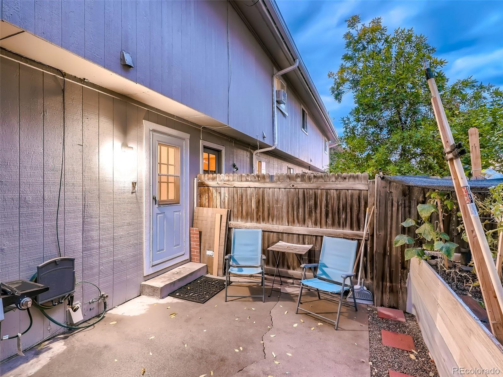 1230 South Reed Street, Unit 4 Lakewood, CO 80232 - Photo 28 of 28 a view of deck with table and chairs and potted plants