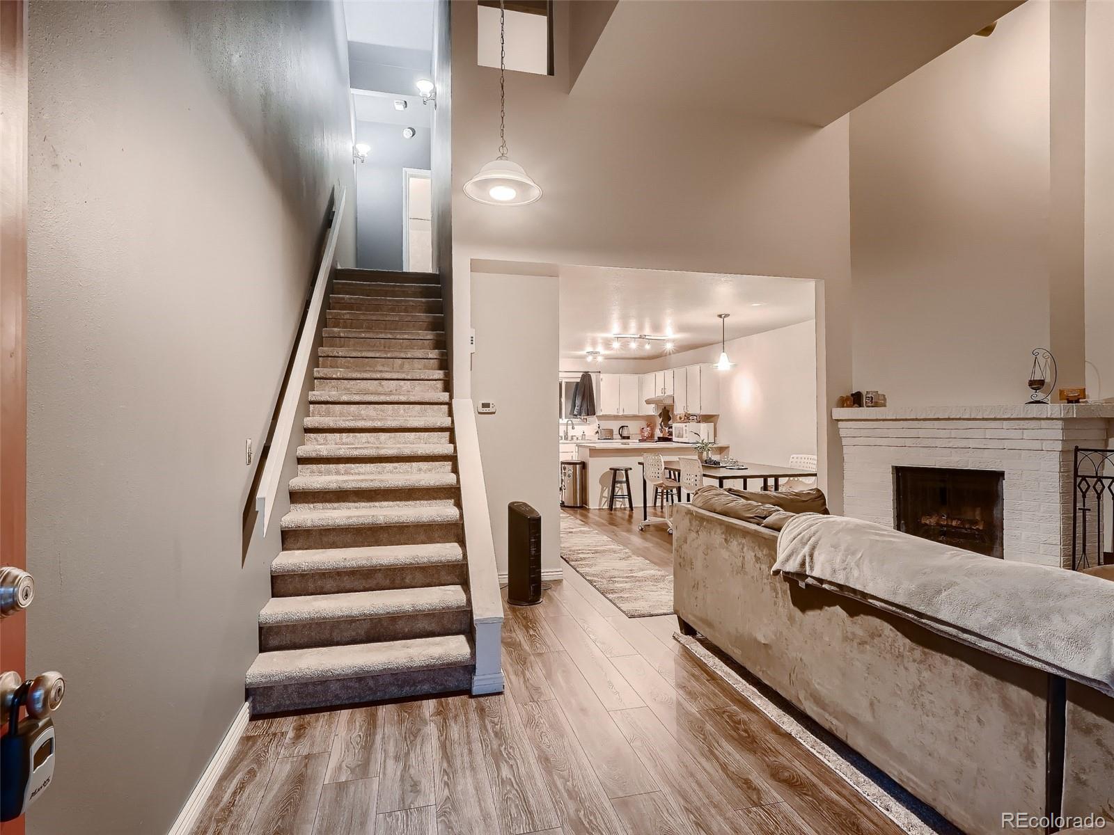 1230 South Reed Street, Unit 4 Lakewood, CO 80232 - Photo 3 of 28 a living room with furniture and a fireplace