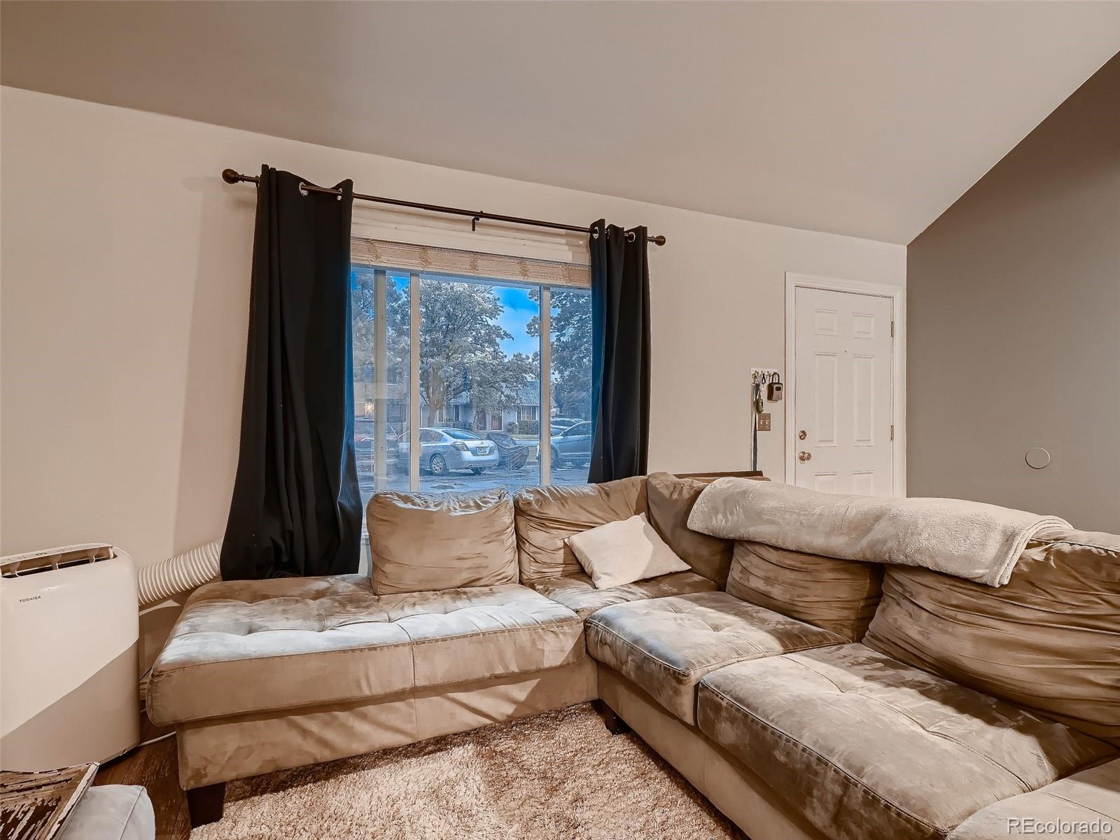 1230 South Reed Street, Unit 4 Lakewood, CO 80232 - Photo 4 of 28 a living room with furniture and a large window