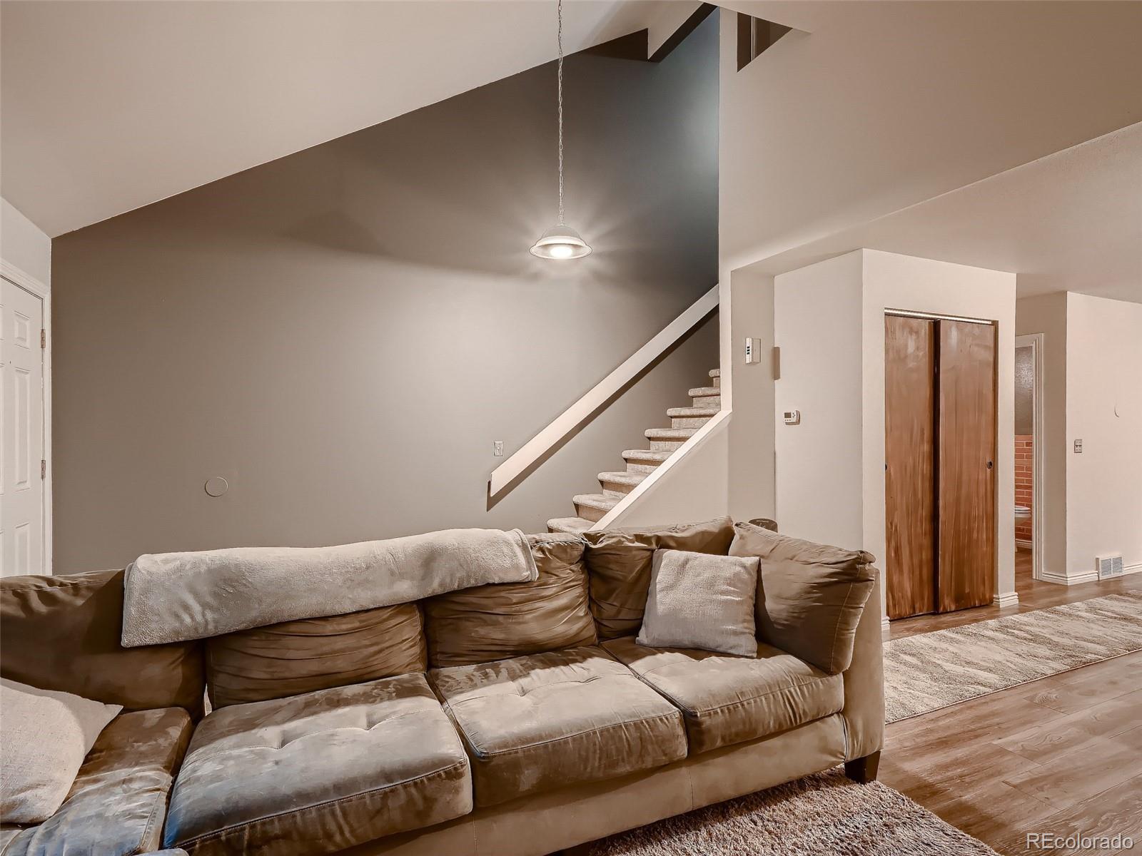 1230 South Reed Street, Unit 4 Lakewood, CO 80232 - Photo 5 of 28 a living room with furniture and stairs