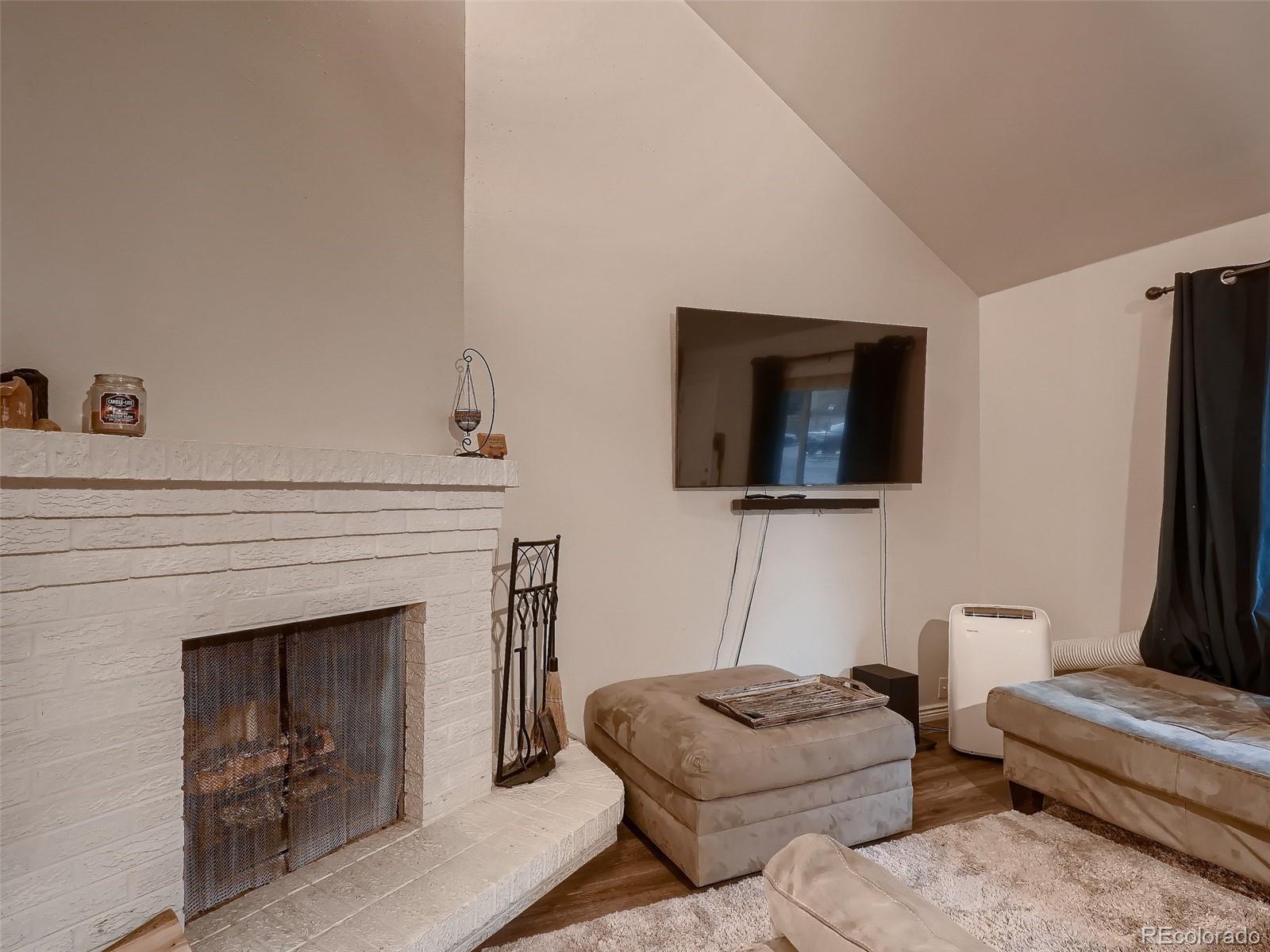 1230 South Reed Street, Unit 4 Lakewood, CO 80232 - Photo 6 of 28 a living room with furniture and a fireplace