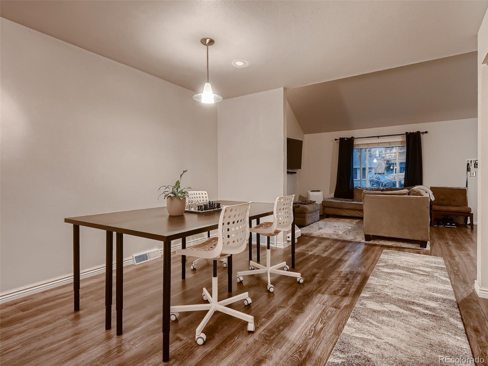 1230 South Reed Street, Unit 4 Lakewood, CO 80232 - Photo 8 of 28 a living room with furniture a rug and a chandelier