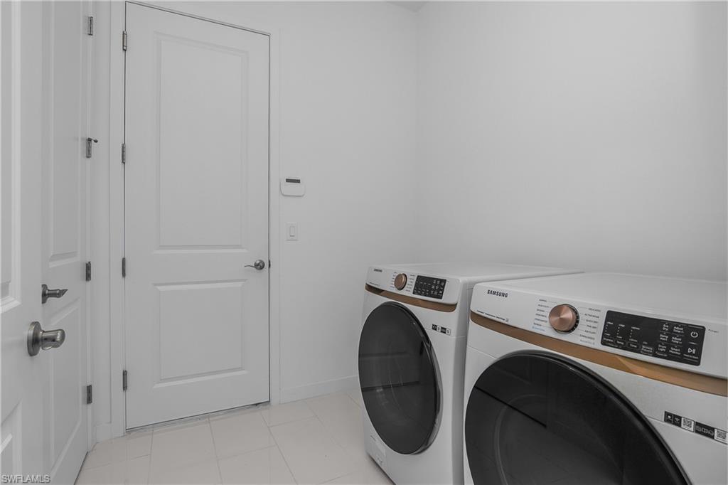 14854 Loggerhead Drive Naples, FL 34120 - Photo 26 of 36 Laundry area with washing machine and clothes dryer
