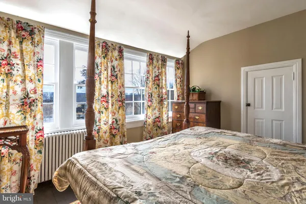 a bedroom with a large bed and a window