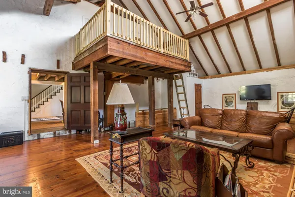 a view of living room filled with furniture and furniture