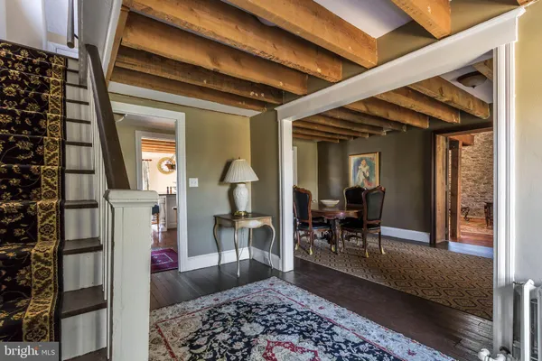 a living room with furniture and a mirror