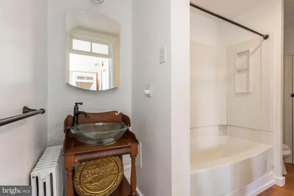 a bathroom with a bathtub and a shower
