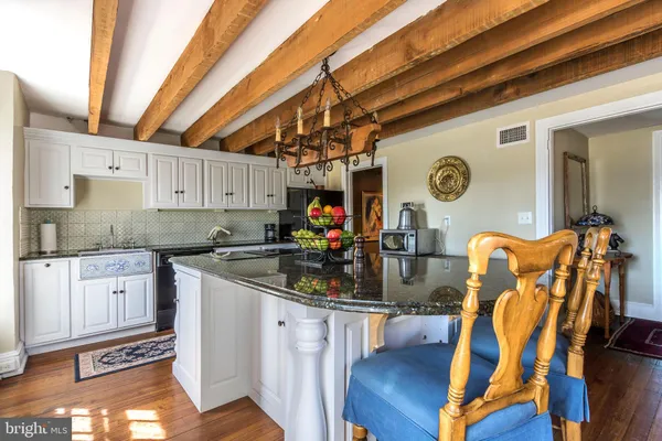 a kitchen with stainless steel appliances granite countertop a stove and cabinets