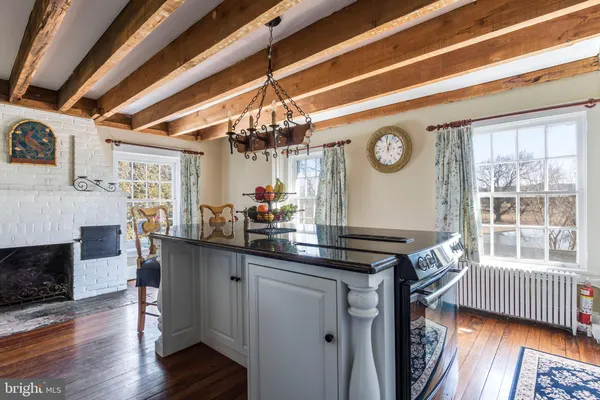 a kitchen that has a lot of cabinets and wooden floor