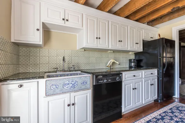 a kitchen with stainless steel appliances granite countertop a stove a refrigerator and cabinets