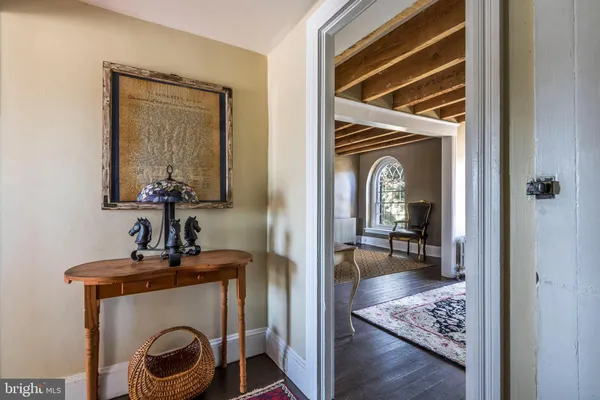 a view of room with a mirror and furniture