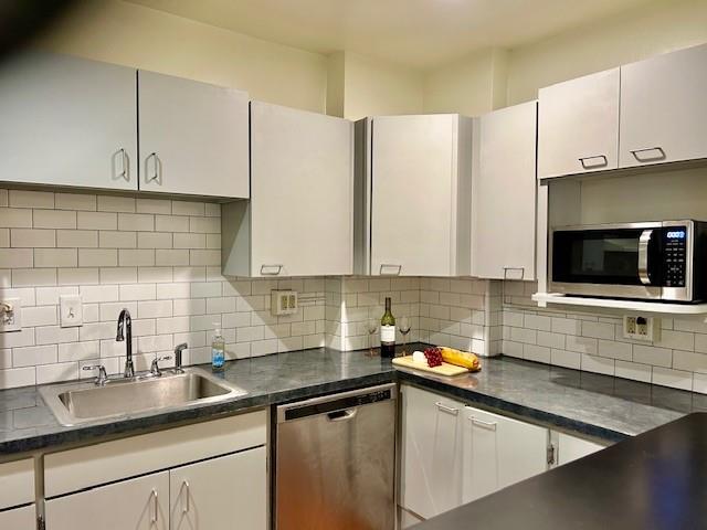 5100 Fifth Avenue, Unit 301 Pittsburgh, PA 15232 - Photo 6 of 25 a kitchen with stainless steel appliances a sink a stove and a microwave
