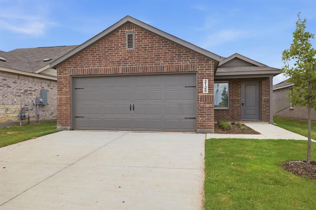 2128 Doc Holliday Road Joshua, TX 76058 - Photo 1 of 28 Brick facade home featuring a two-car garage, concrete driveway, and covered entry
