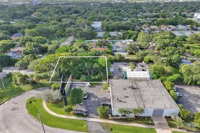 an aerial view of a house with a yard basket ball court and outdoor seating