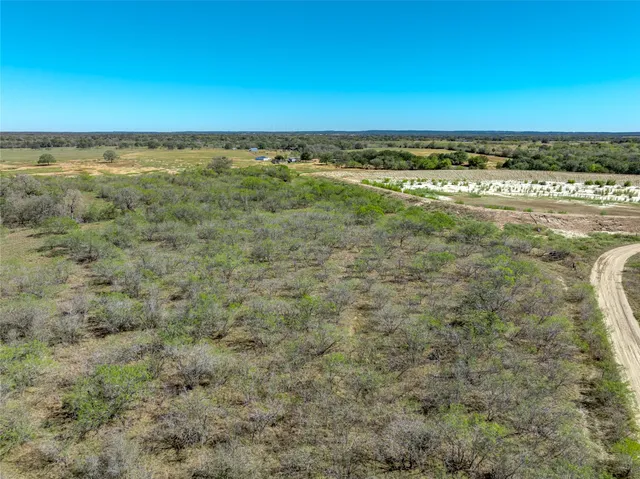 an aerial view of beach and residential houses with outdoor space