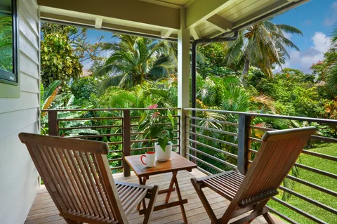 a view of a two chairs in the balcony