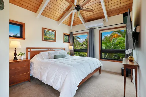 a bedroom with a bed and a large window
