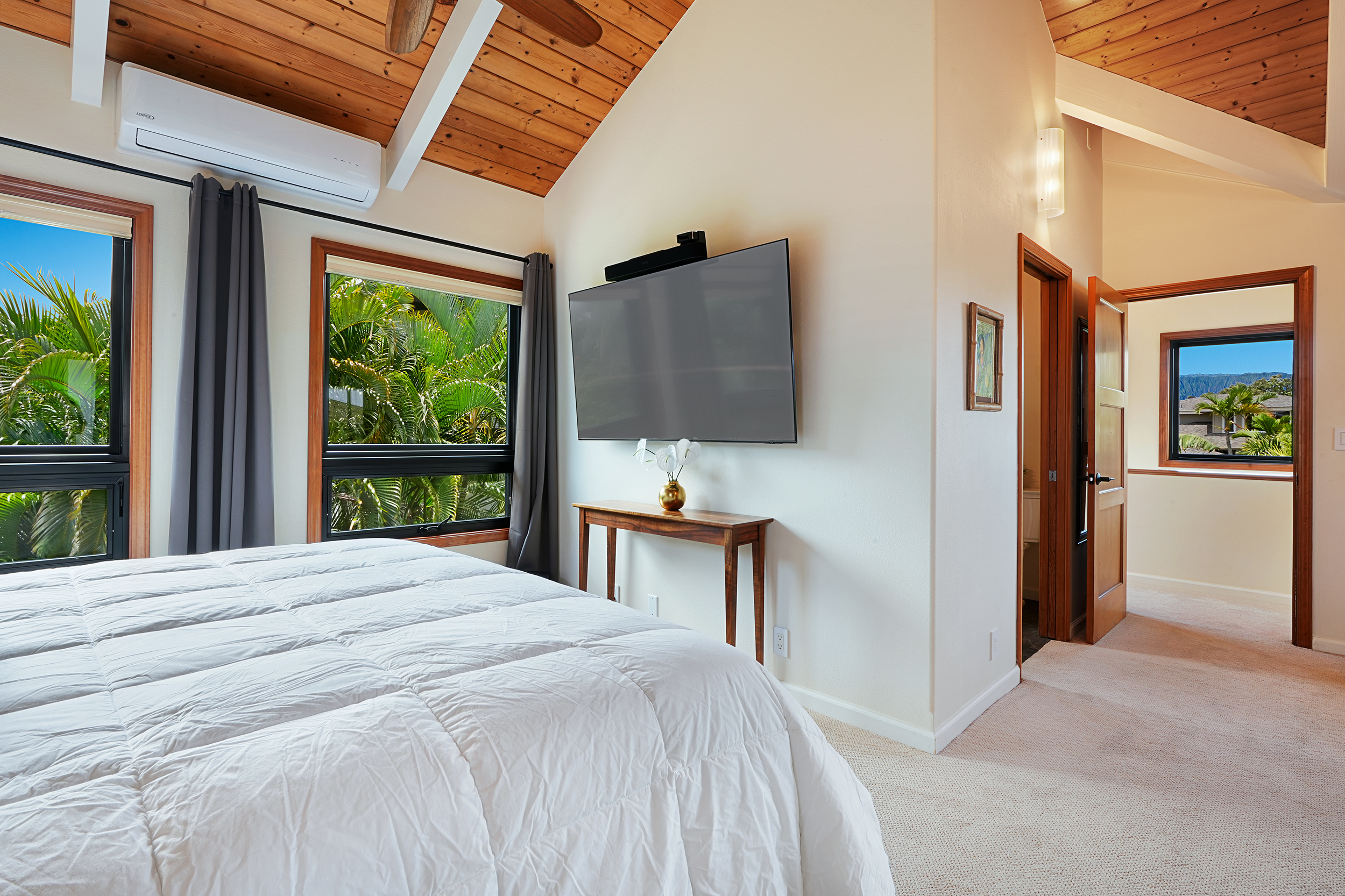 3667 Albert Road Princeville, HI 96722 - Photo 14 of 25 a bedroom with a bed table and flat screen tv