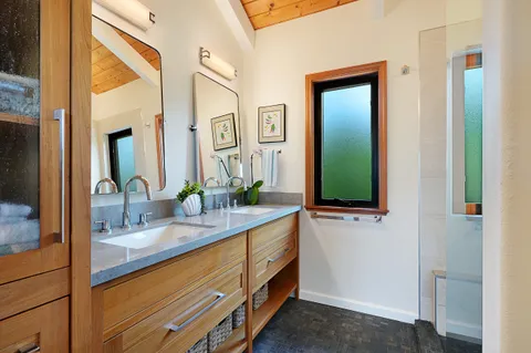a bathroom with a double vanity sink and a mirror