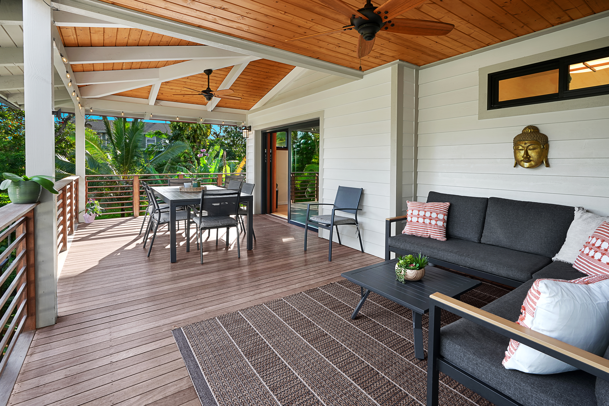 3667 Albert Road Princeville, HI 96722 - Photo 17 of 25 a view of a patio with dining table and chairs under a large umbrella