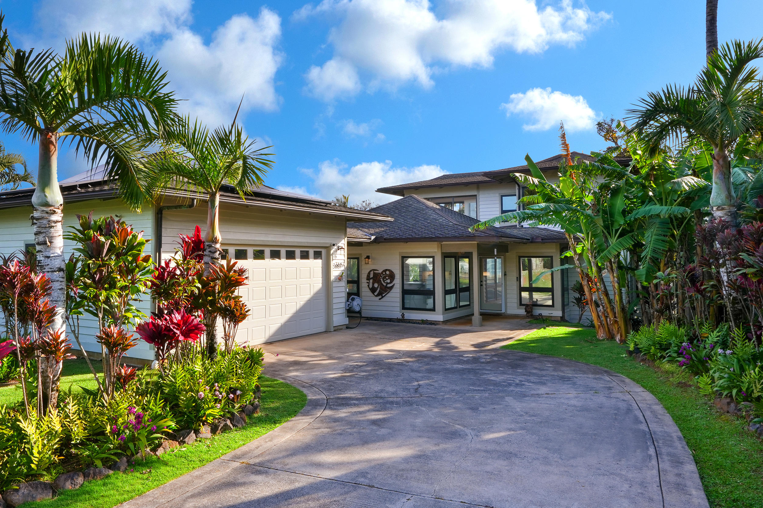 3667 Albert Road Princeville, HI 96722 - Photo 2 of 25 a front view of a house with a yard and potted plants