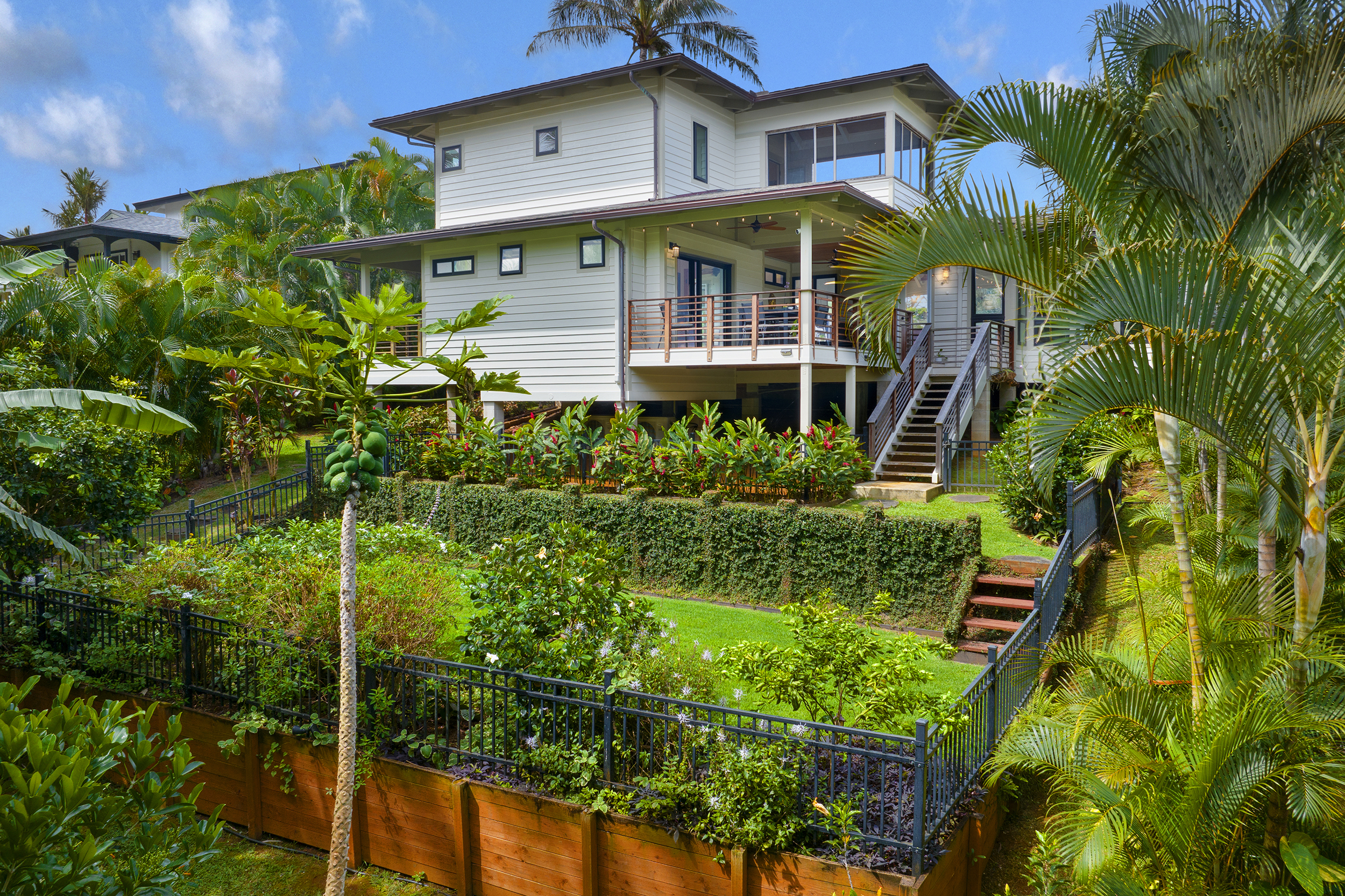 3667 Albert Road Princeville, HI 96722 - Photo 21 of 25 a front view of a house with a garden