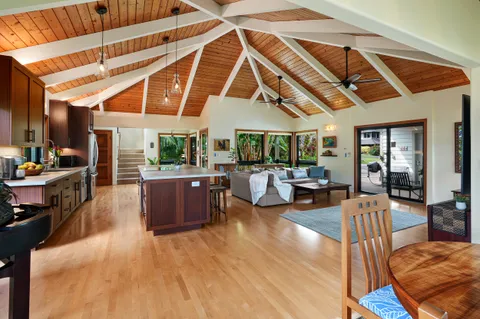a living room with furniture and kitchen view