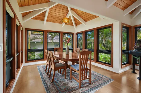 a dining room with furniture window and wooden floor