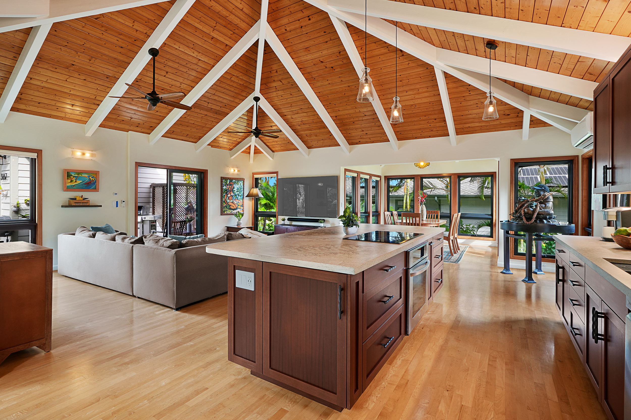 3667 Albert Road Princeville, HI 96722 - Photo 6 of 25 a large kitchen with stainless steel appliances granite countertop a large stove a sink dishwasher and a dining table with wooden floor