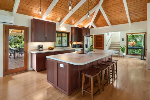 a kitchen with a stove a sink and a refrigerator