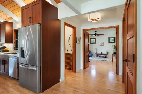 a view of a refrigerator in kitchen and wooden floor
