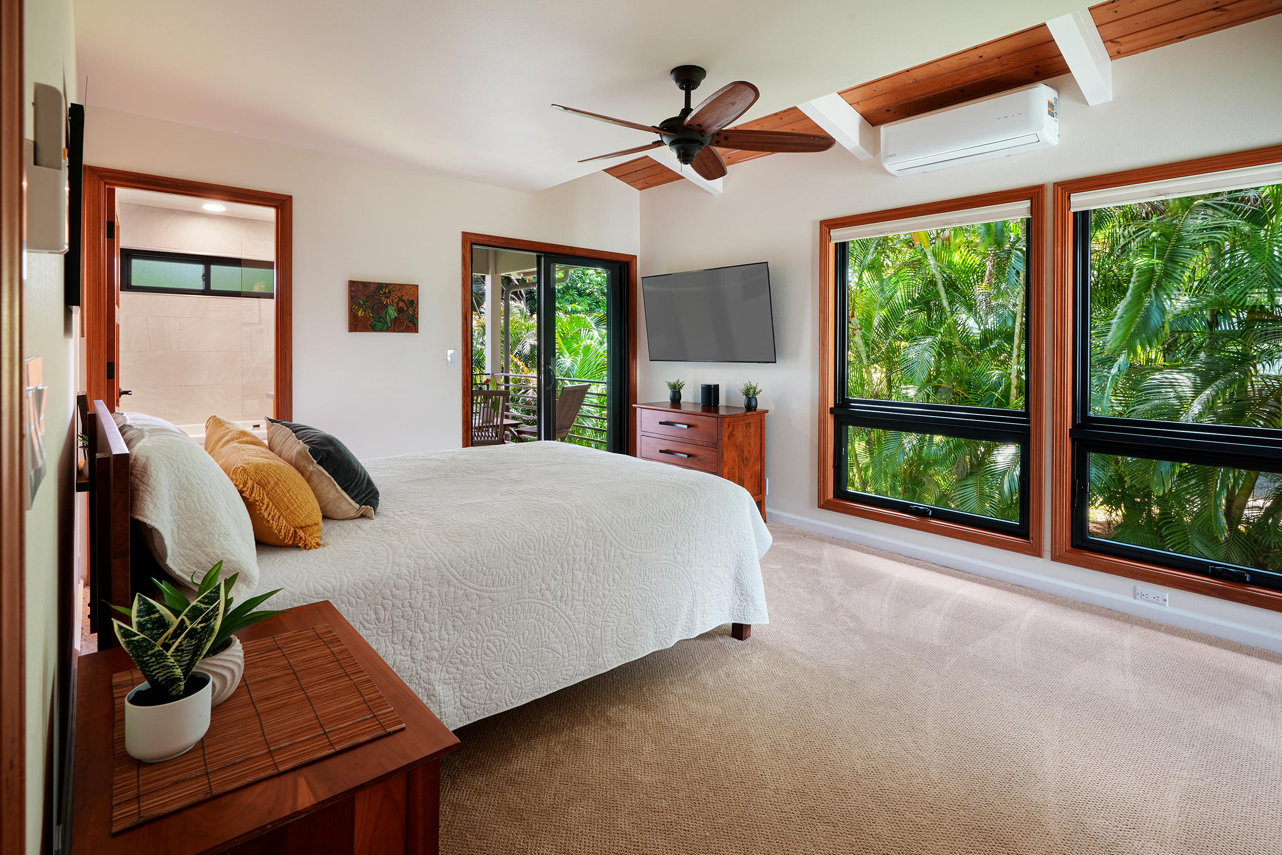 3667 Albert Road Princeville, HI 96722 - Photo 10 of 25 a bed sitting in a spacious bedroom next to a large window