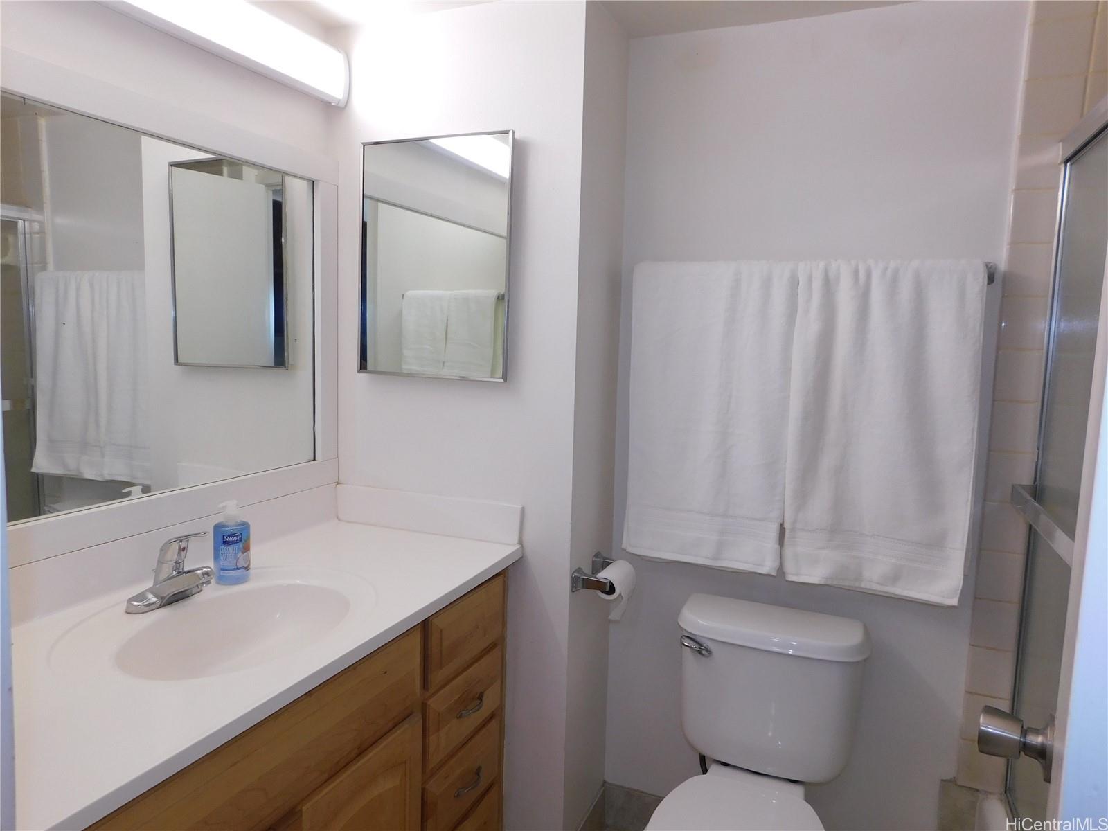 710 Lunalilo Street, Unit 301 Honolulu, HI 96813 - Photo 16 of 21 a bathroom with a sink vanity mirror and toilet