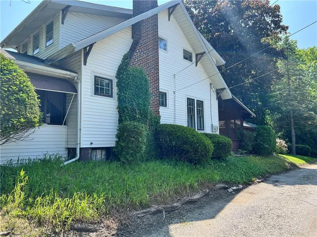 a view of a house with a yard and plants