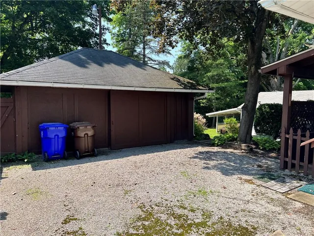 a backyard of a house with barbeque oven and yard
