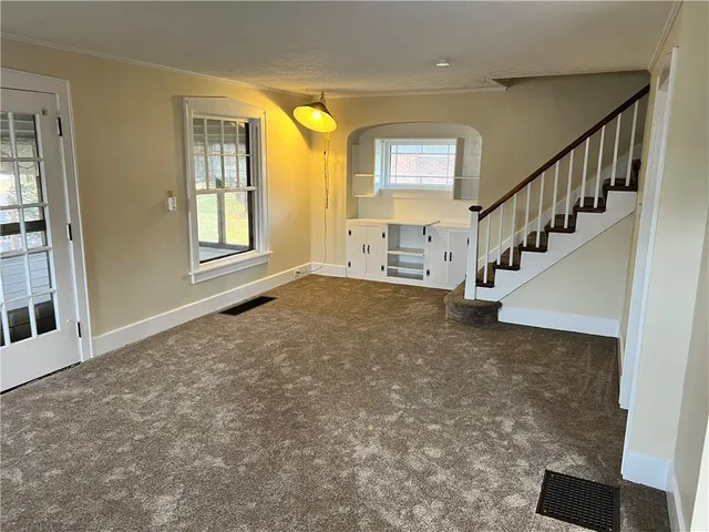a view of an entryway with wooden floor and windows